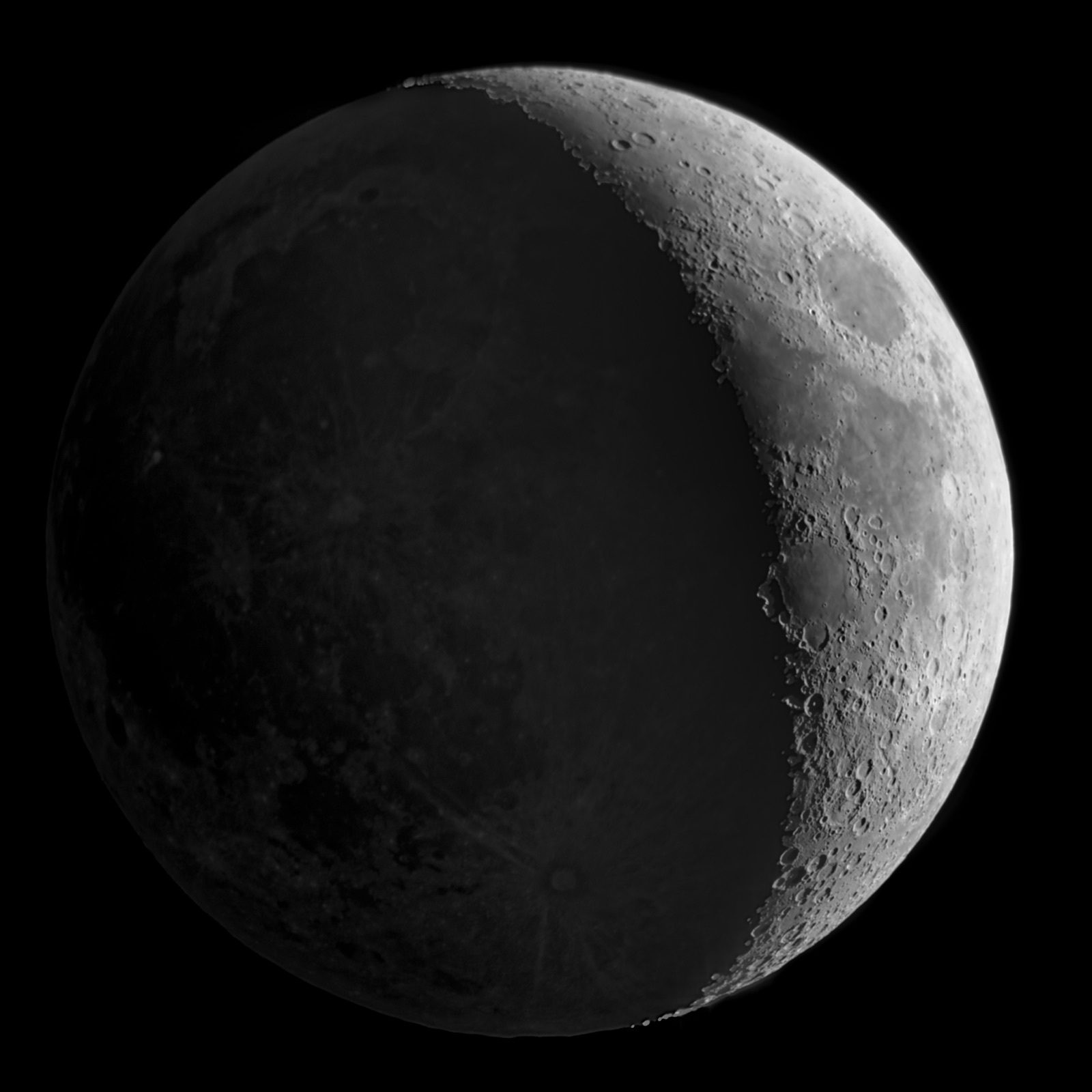 A crescent Moon with the dark side faintly lit by earthshine